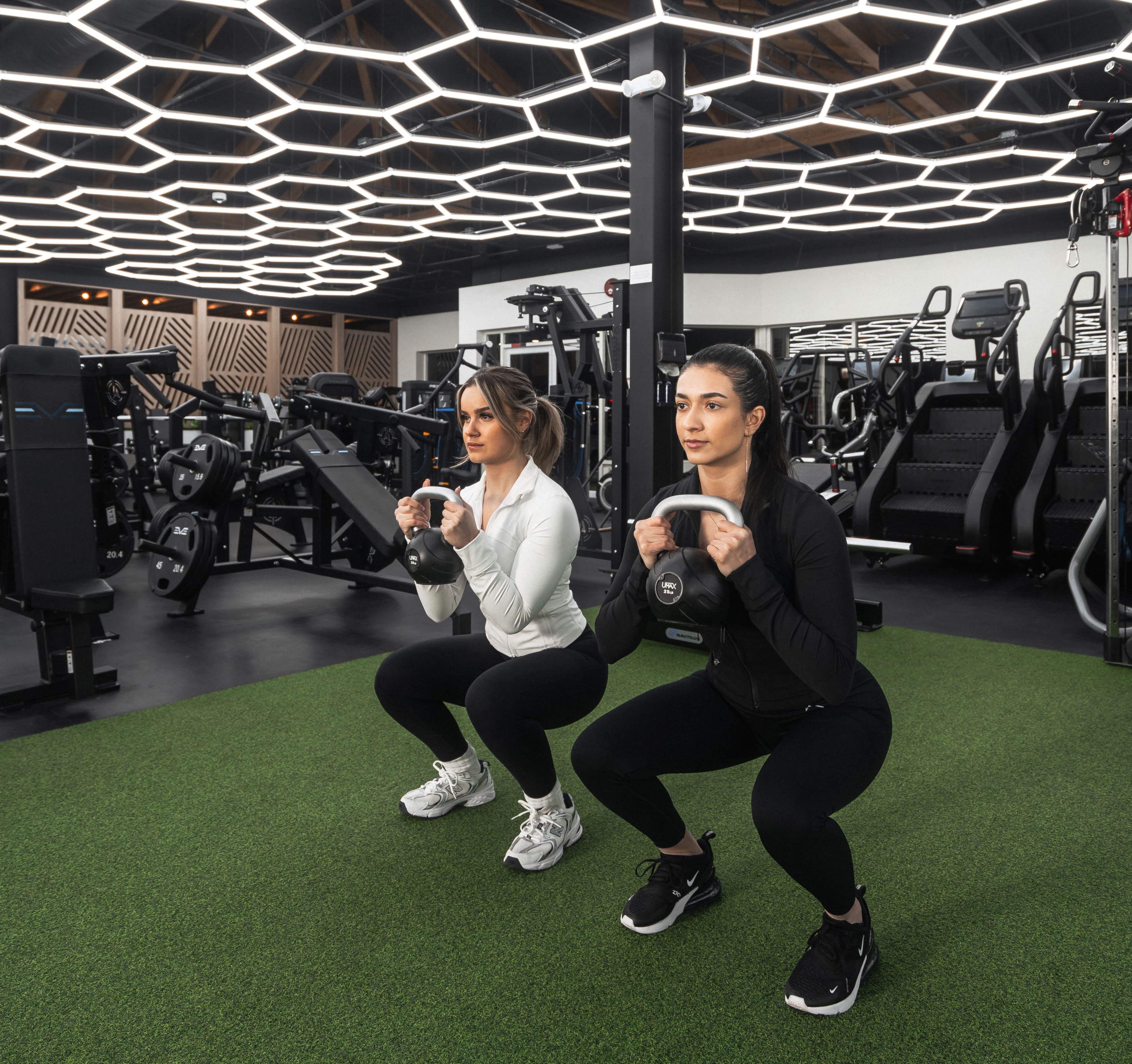 Two Women working out side by side