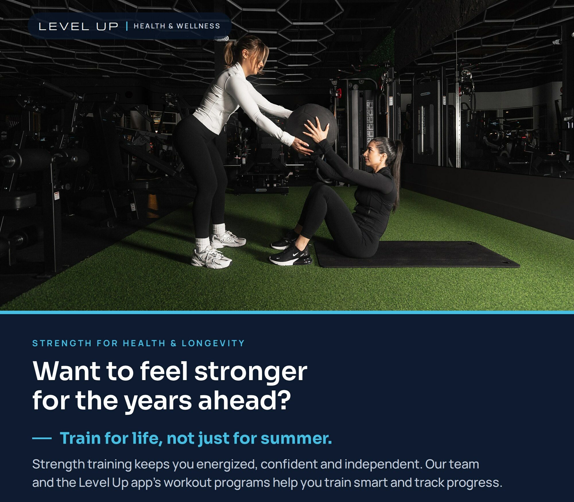 Two women exercising together with a medicine ball at Level Up. Build strength for health and longevity with team support and workout programs in the Level Up app. Register for the October offer.